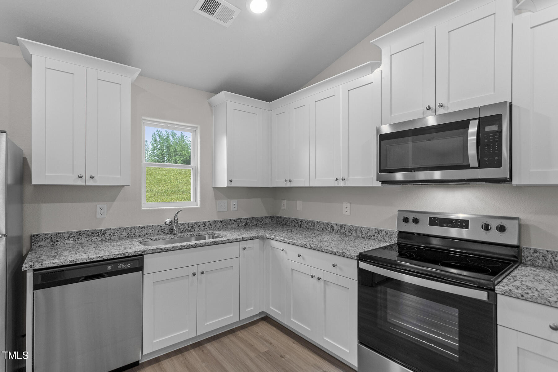 65 Crow Field Street Roxboro, NC 27574 - Photo 5 of 16 a kitchen with granite countertop white cabinets stainless steel appliances and a sink