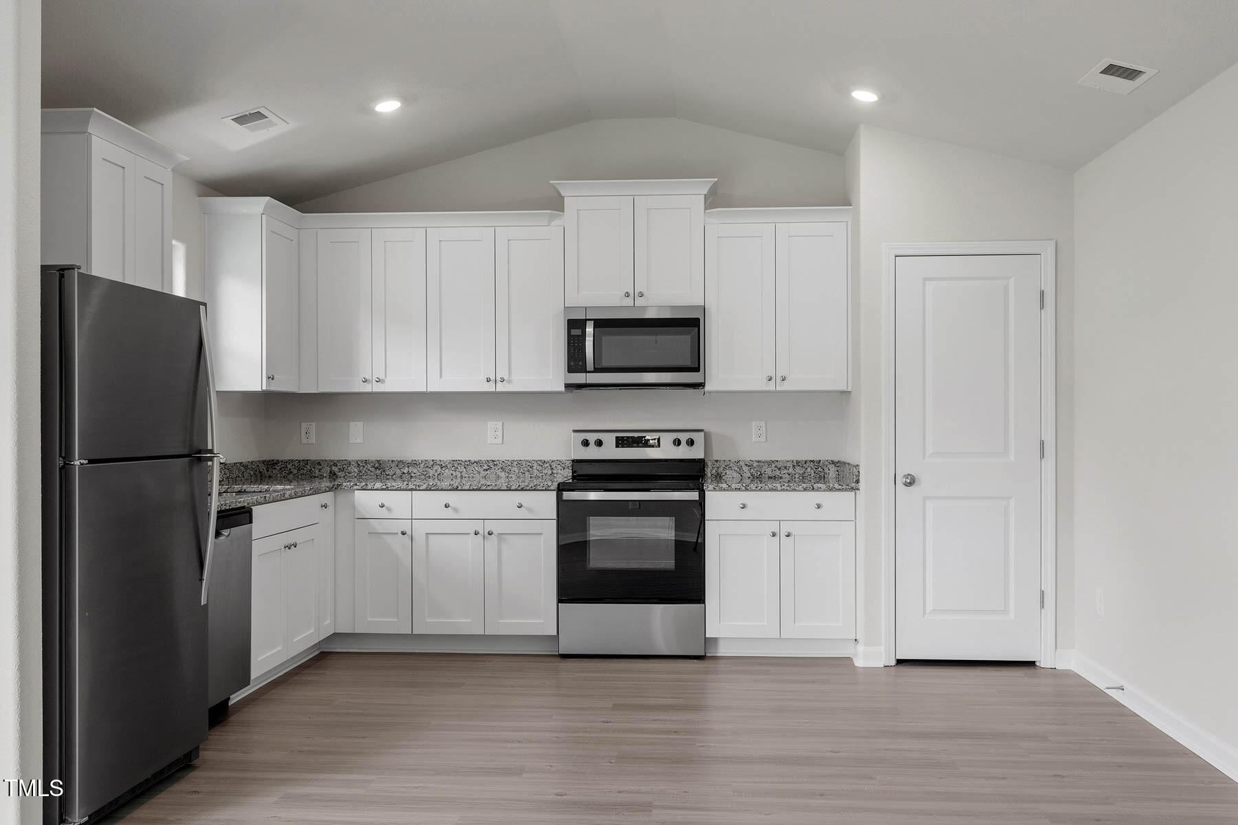 65 Crow Field Street Roxboro, NC 27574 - Photo 7 of 16 a kitchen with granite countertop white cabinets and stainless steel appliances