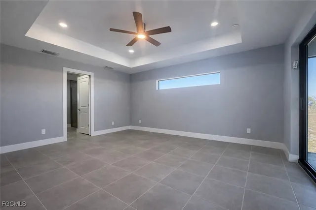 an empty room with closet and windows
