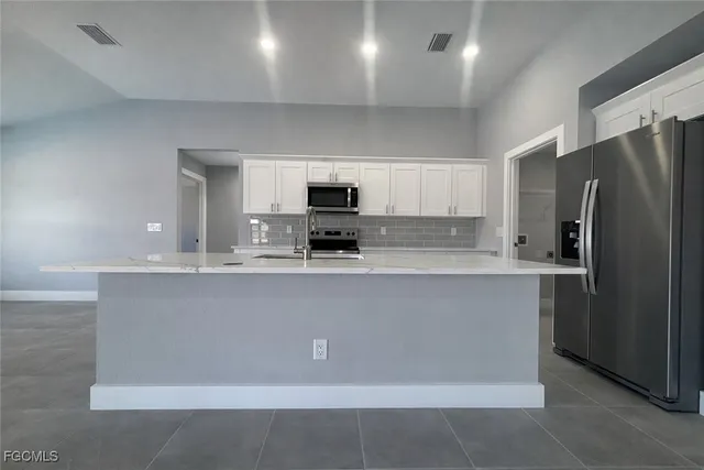a large kitchen with cabinets
