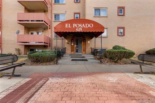 a front view of a building with sitting area