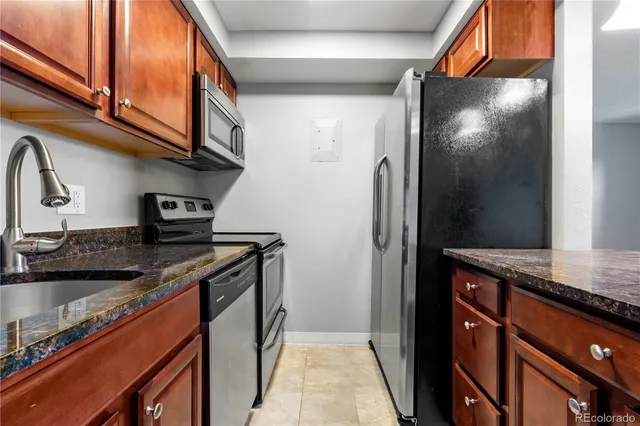 a kitchen with stainless steel appliances granite countertop a stove and a refrigerator
