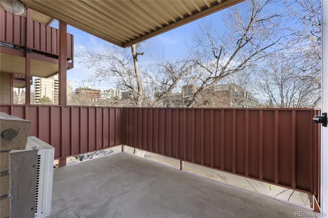 a view of a backyard with wooden fence