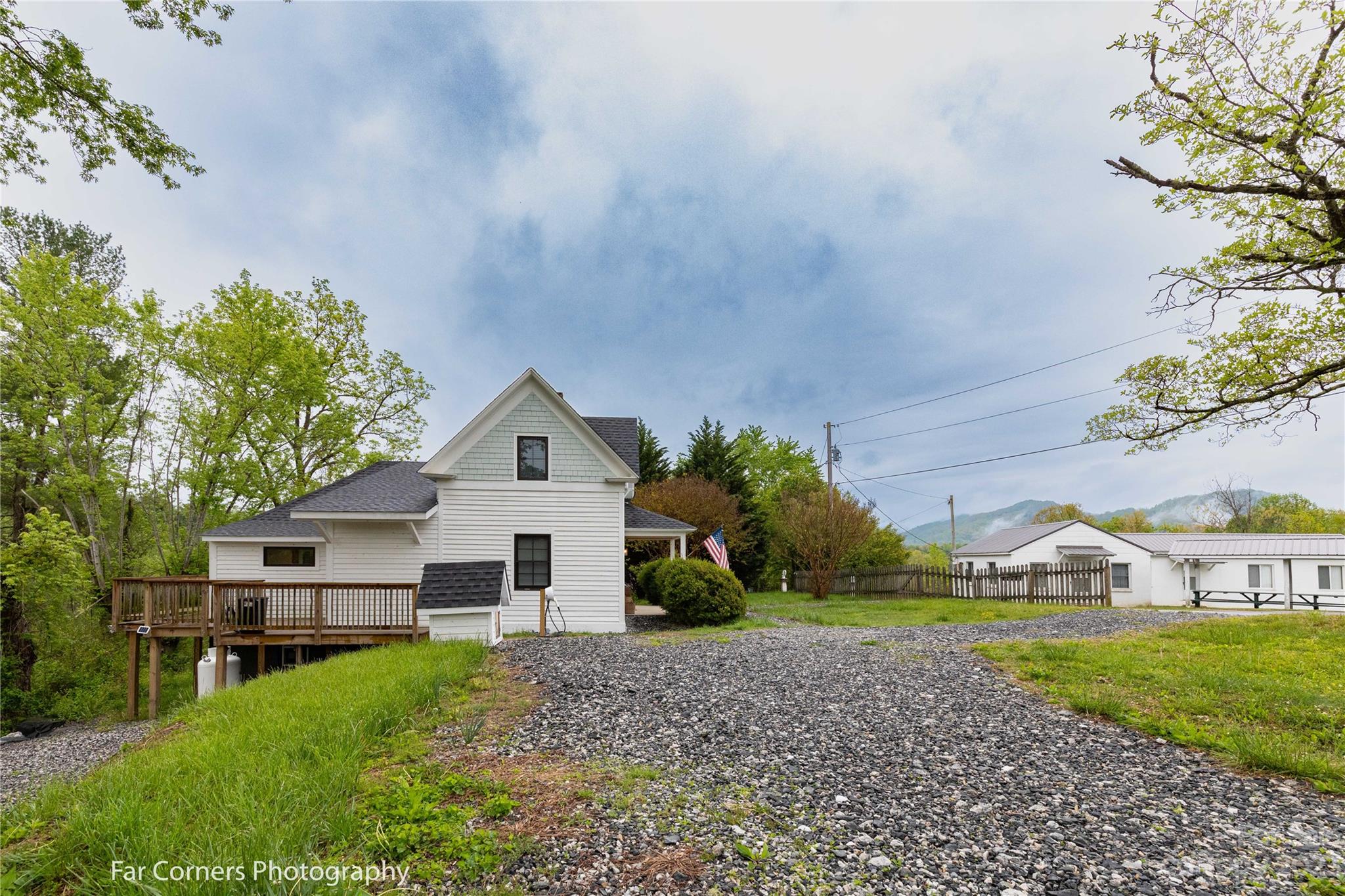 29 South School Road Marshall, NC 28753 - Photo 21 of 24 a view of a yard in front of a house with plants and large tree