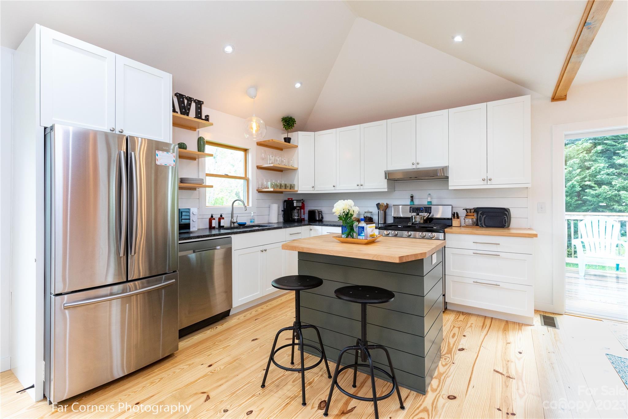 29 South School Road Marshall, NC 28753 - Photo 8 of 24 a kitchen with stainless steel appliances a refrigerator a stove a sink dishwasher and a refrigerator with wooden floor