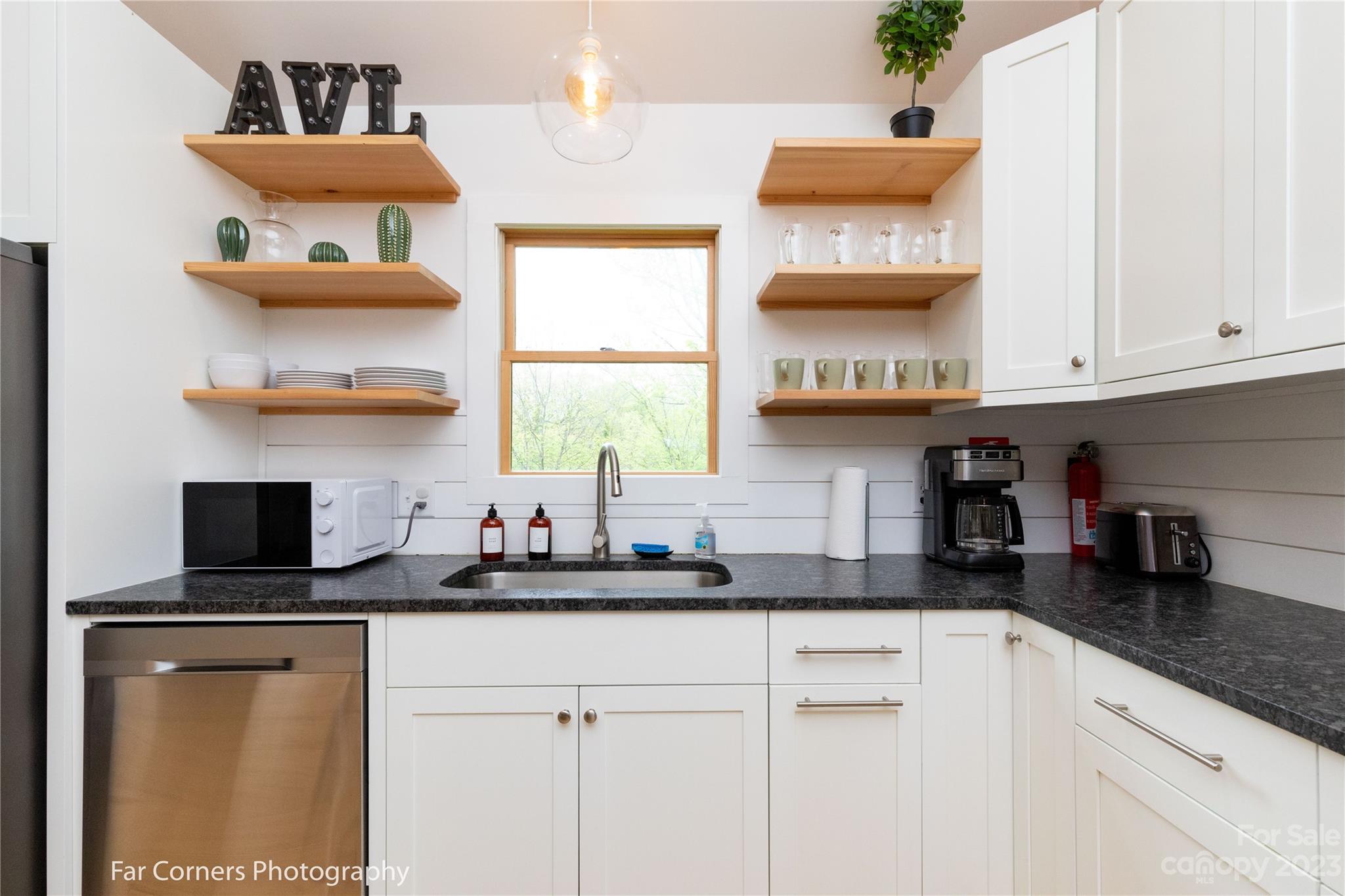 29 South School Road Marshall, NC 28753 - Photo 9 of 24 a kitchen with a sink dishwasher a refrigerator and a stove