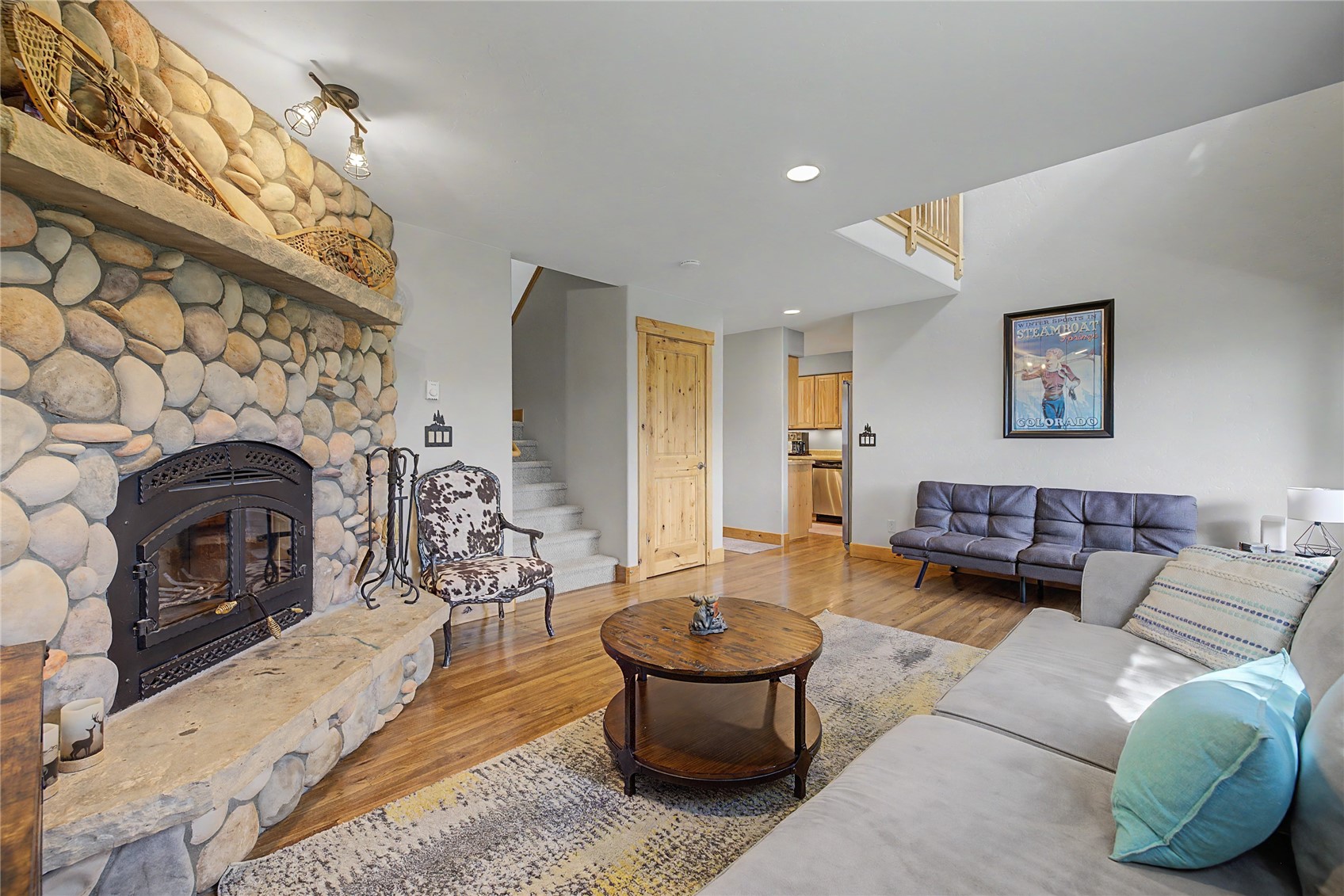 6726 Ryan Gulch Road, Unit 6726 Wildernest, CO 80498 - Photo 2 of 39 a living room with furniture and a fireplace