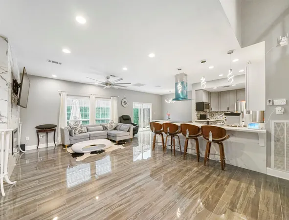 a living room with lots of furniture and kitchen view