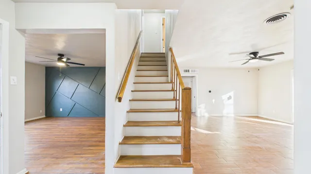 a view of entryway and hall with wooden floor