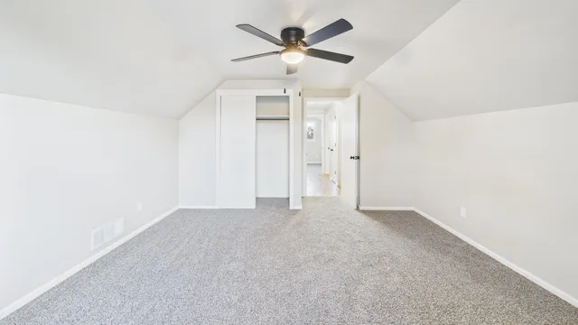 an empty room with fan and a ceiling fan