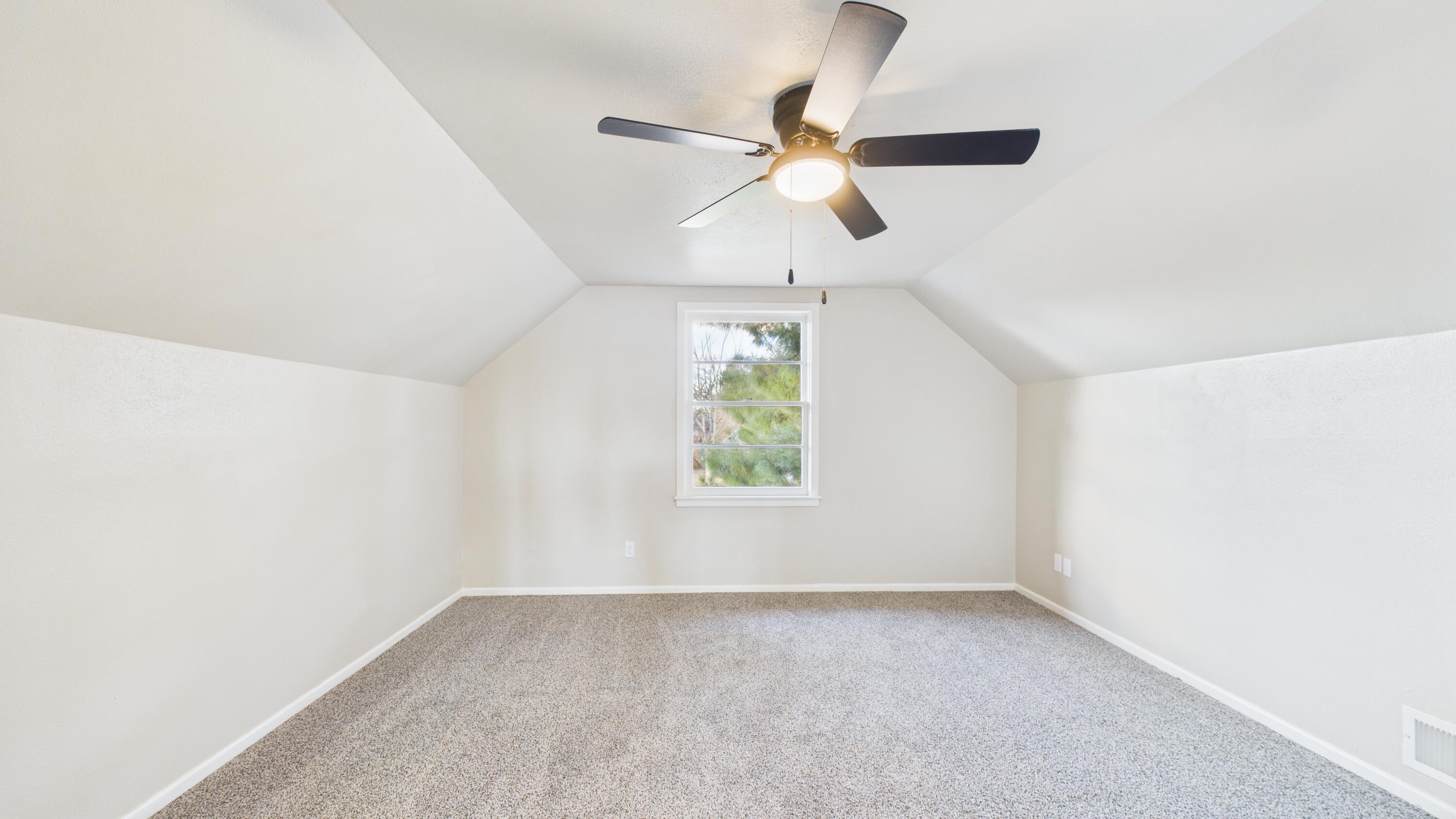 2013 69th Street Lubbock, TX 79412 - Photo 14 of 19 an empty room with a window and a fan