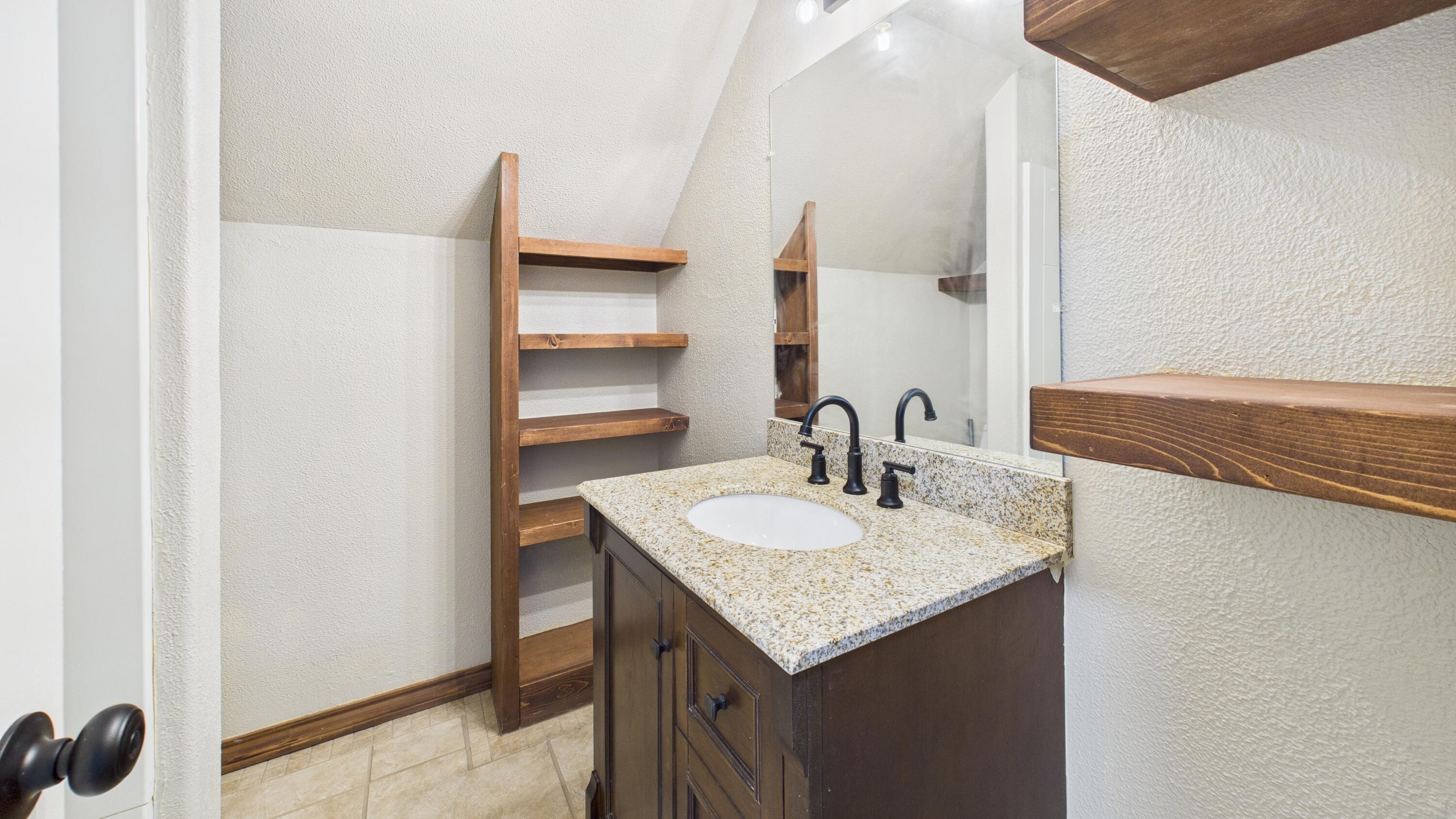 2013 69th Street Lubbock, TX 79412 - Photo 16 of 19 a bathroom with a sink and a mirror