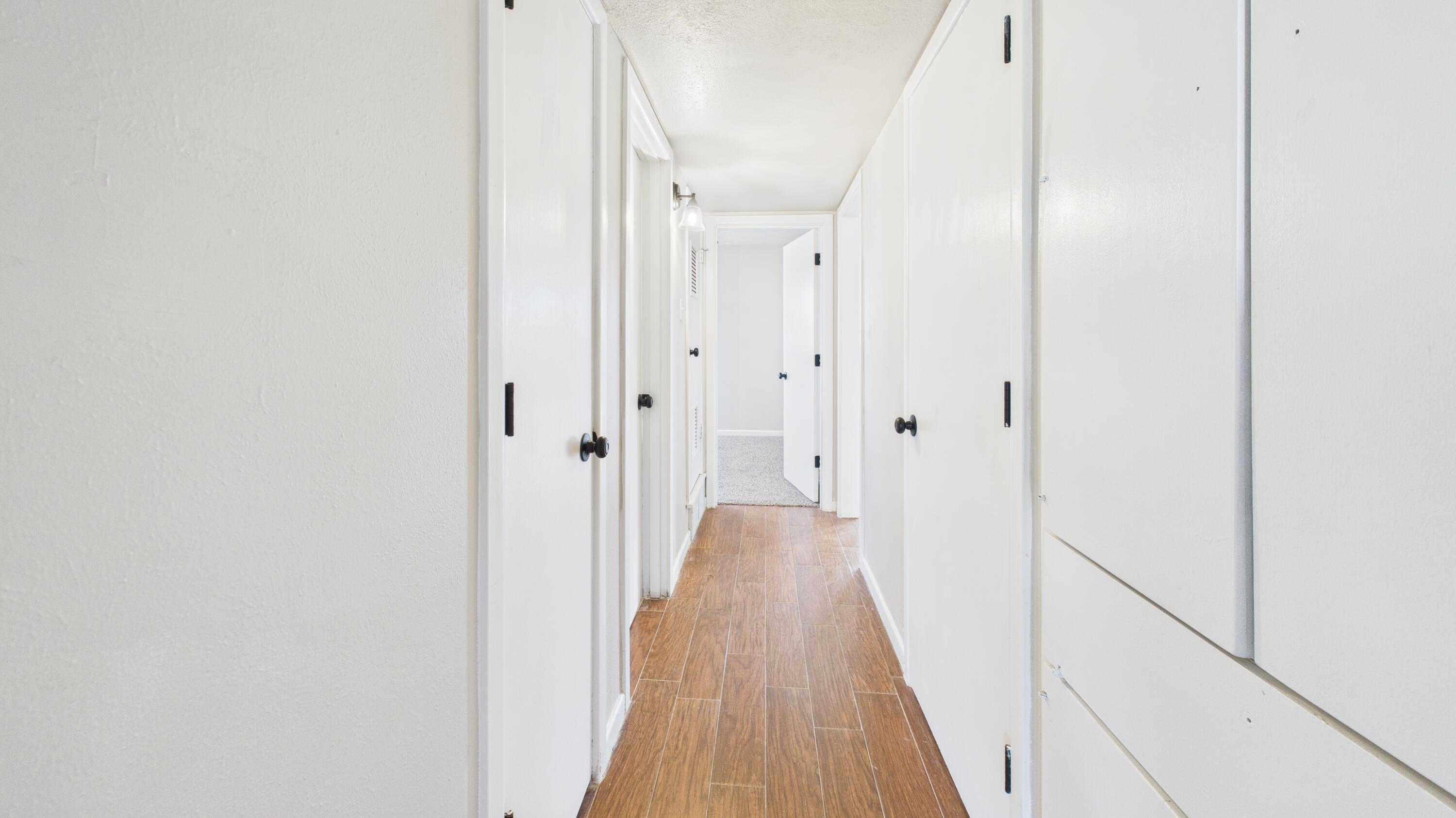 2013 69th Street Lubbock, TX 79412 - Photo 19 of 19 a view of a hallway with wooden floor