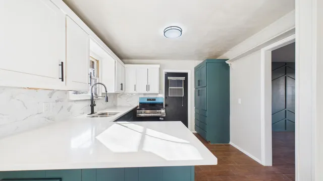 a kitchen with a sink and a refrigerator