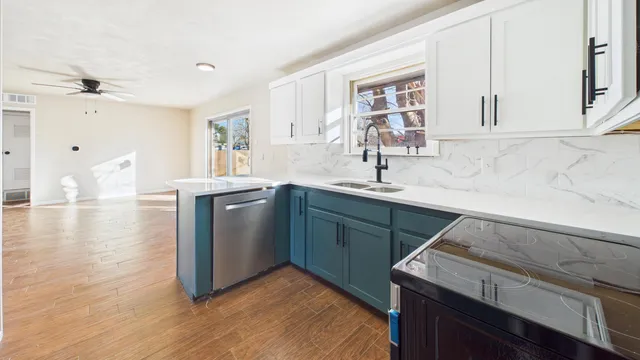 a kitchen with a sink cabinets and wooden floor