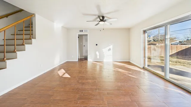 wooden floor in an empty room with a window