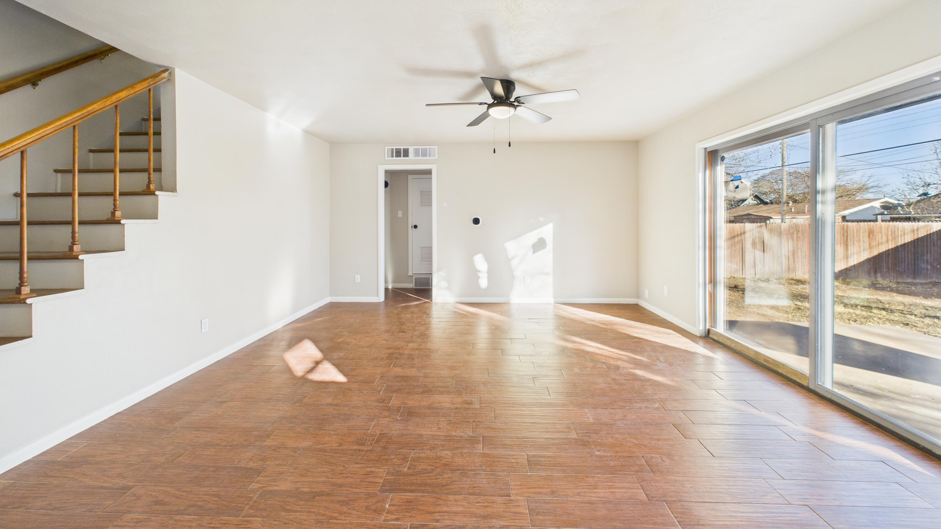 2013 69th Street Lubbock, TX 79412 - Photo 9 of 19 wooden floor in an empty room with a window