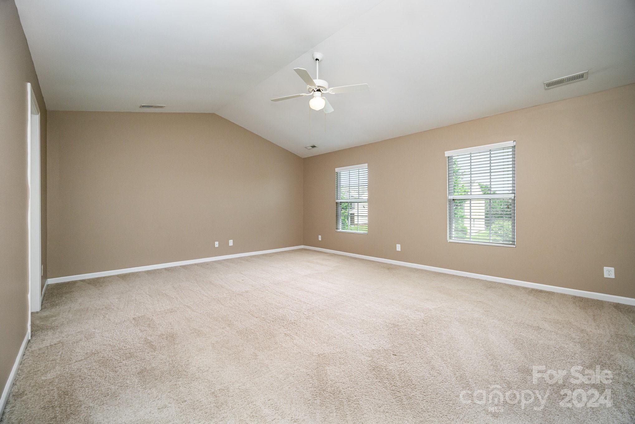 1007 Yellow Bee Road Indian Trail, NC 28079 - Photo 11 of 21 an empty room with ceiling fan and window