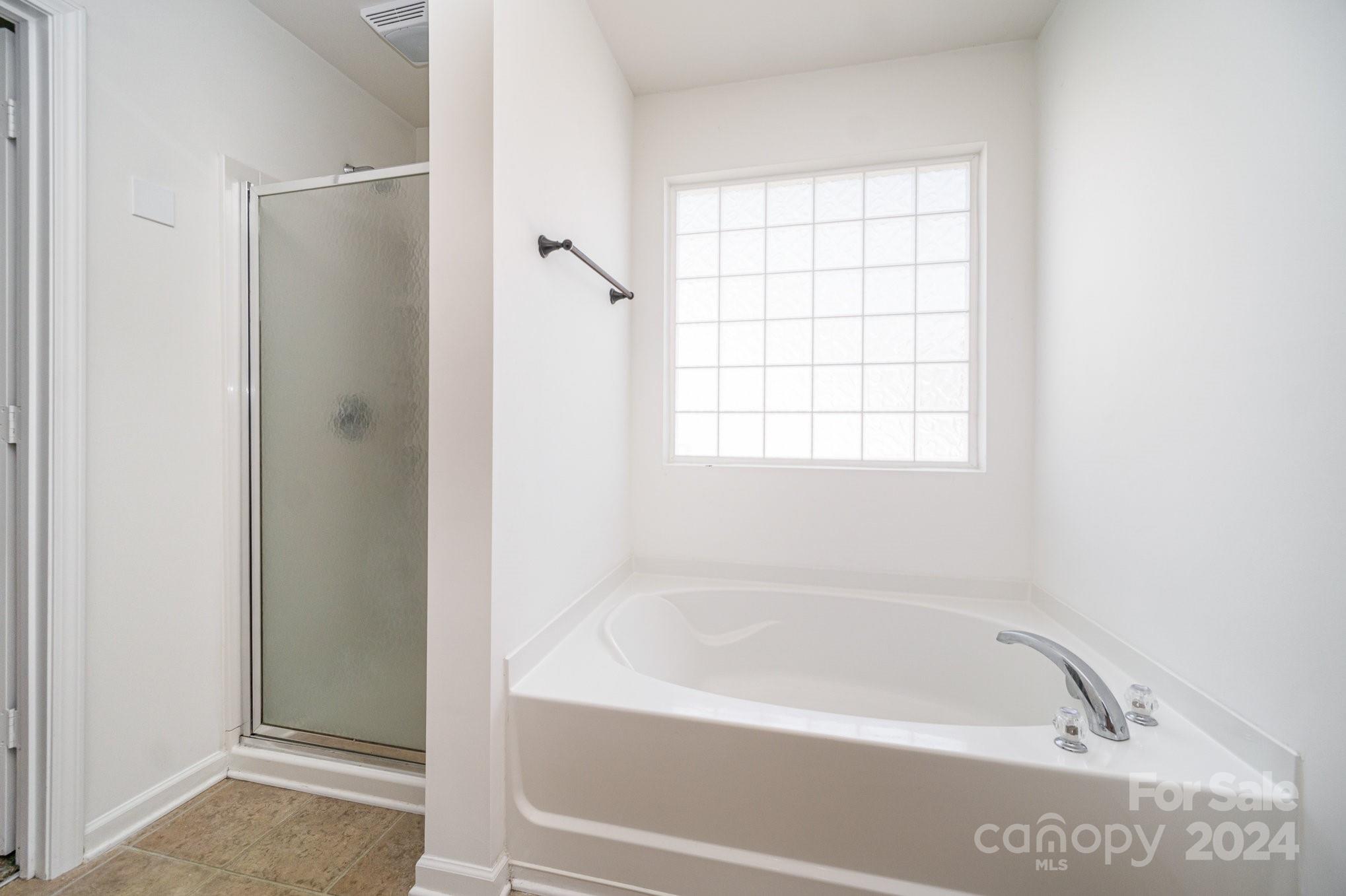 1007 Yellow Bee Road Indian Trail, NC 28079 - Photo 13 of 21 a white bath tub sitting next to a window