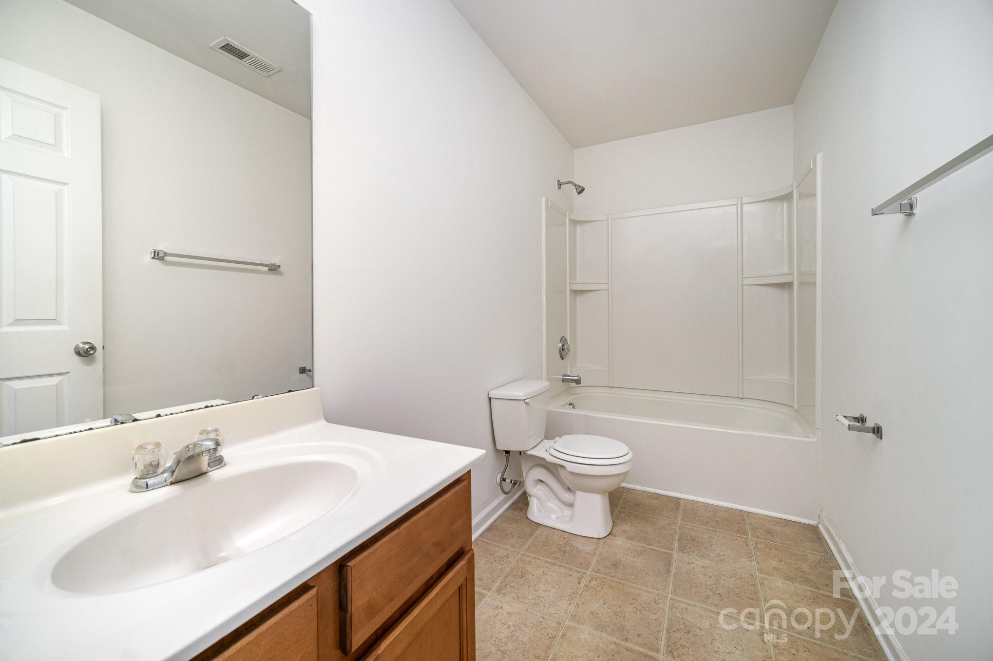 1007 Yellow Bee Road Indian Trail, NC 28079 - Photo 16 of 21 a bathroom with a sink a toilet and shower