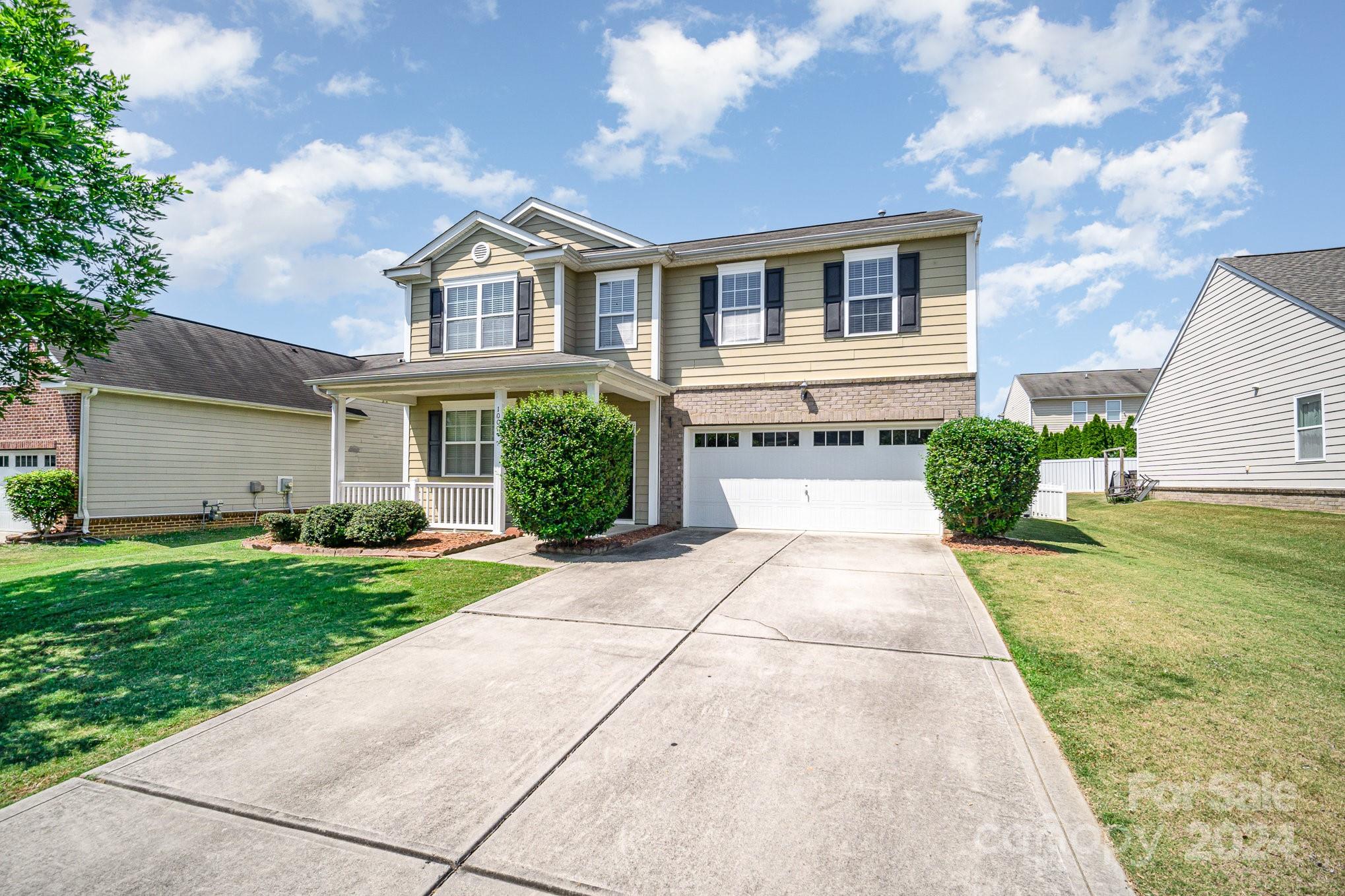 1007 Yellow Bee Road Indian Trail, NC 28079 - Photo 2 of 21 a front view of a house with a yard and garage
