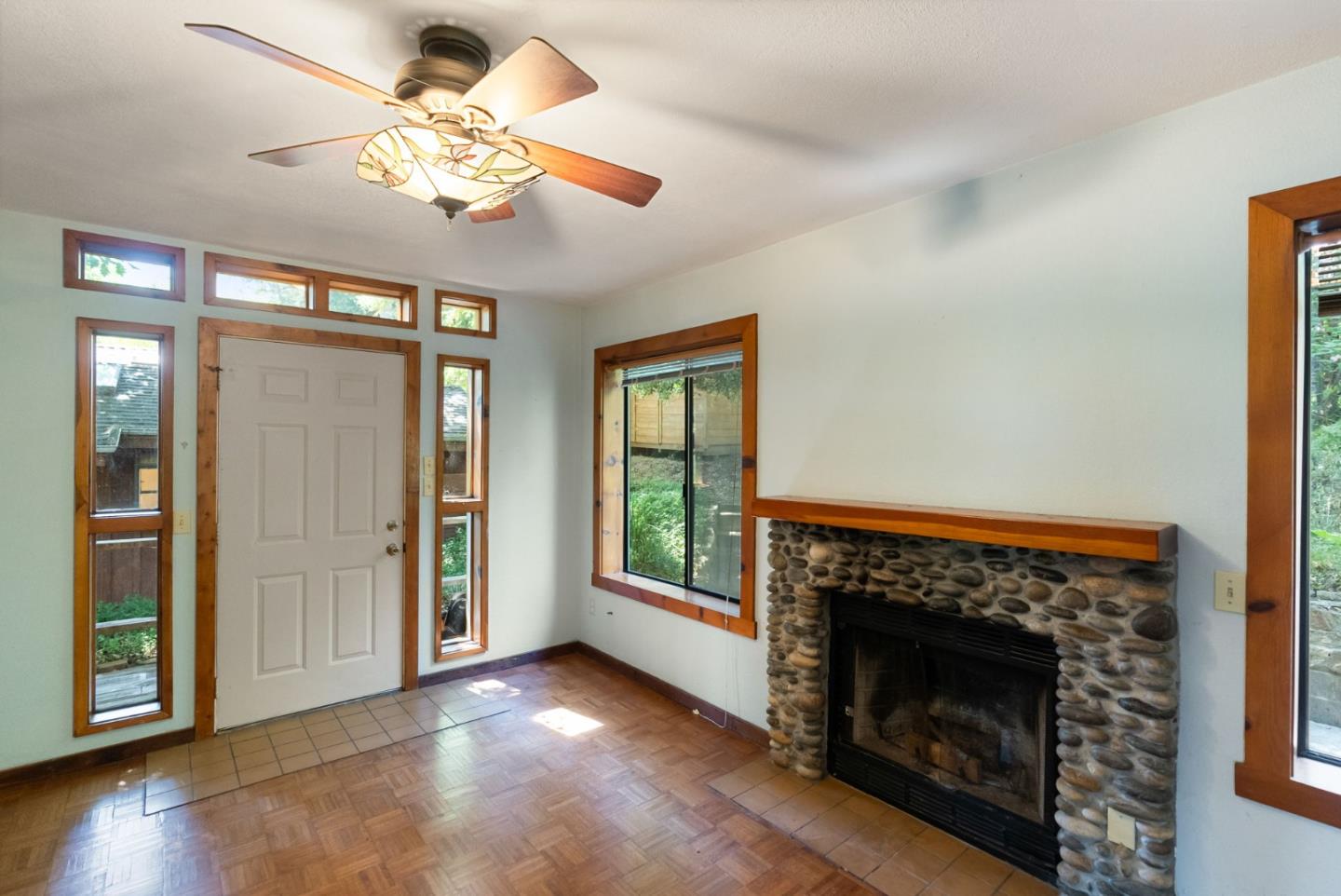 324 Felton Empire Road Felton, CA 95018 - Photo 13 of 43 a view of an empty room with wooden floor fireplace and a window