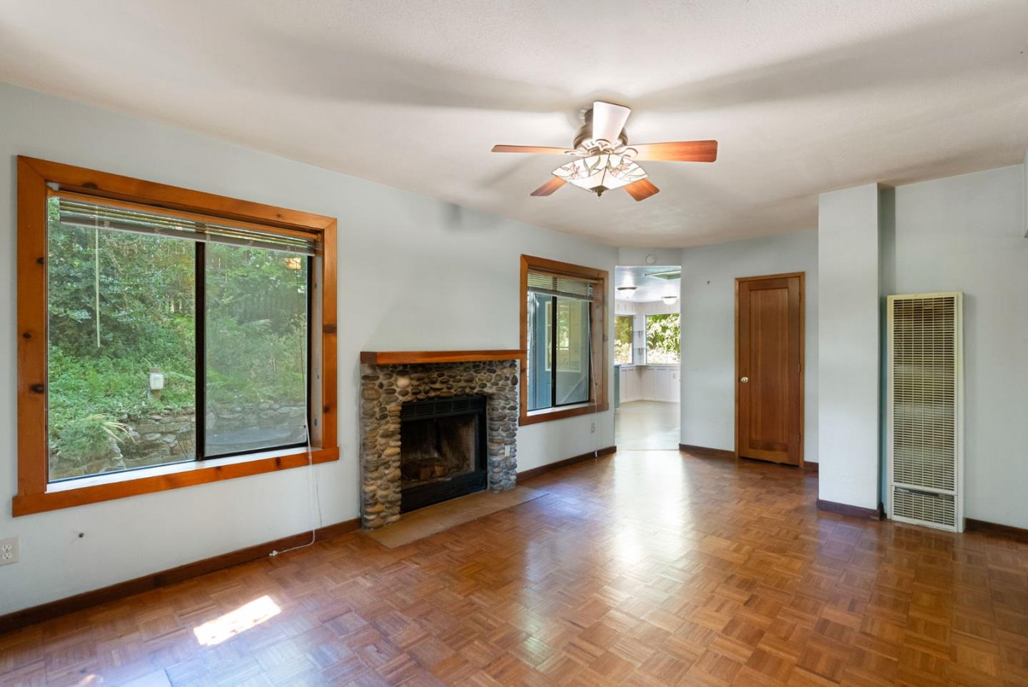 324 Felton Empire Road Felton, CA 95018 - Photo 14 of 43 an empty room with windows fireplace and wooden floor