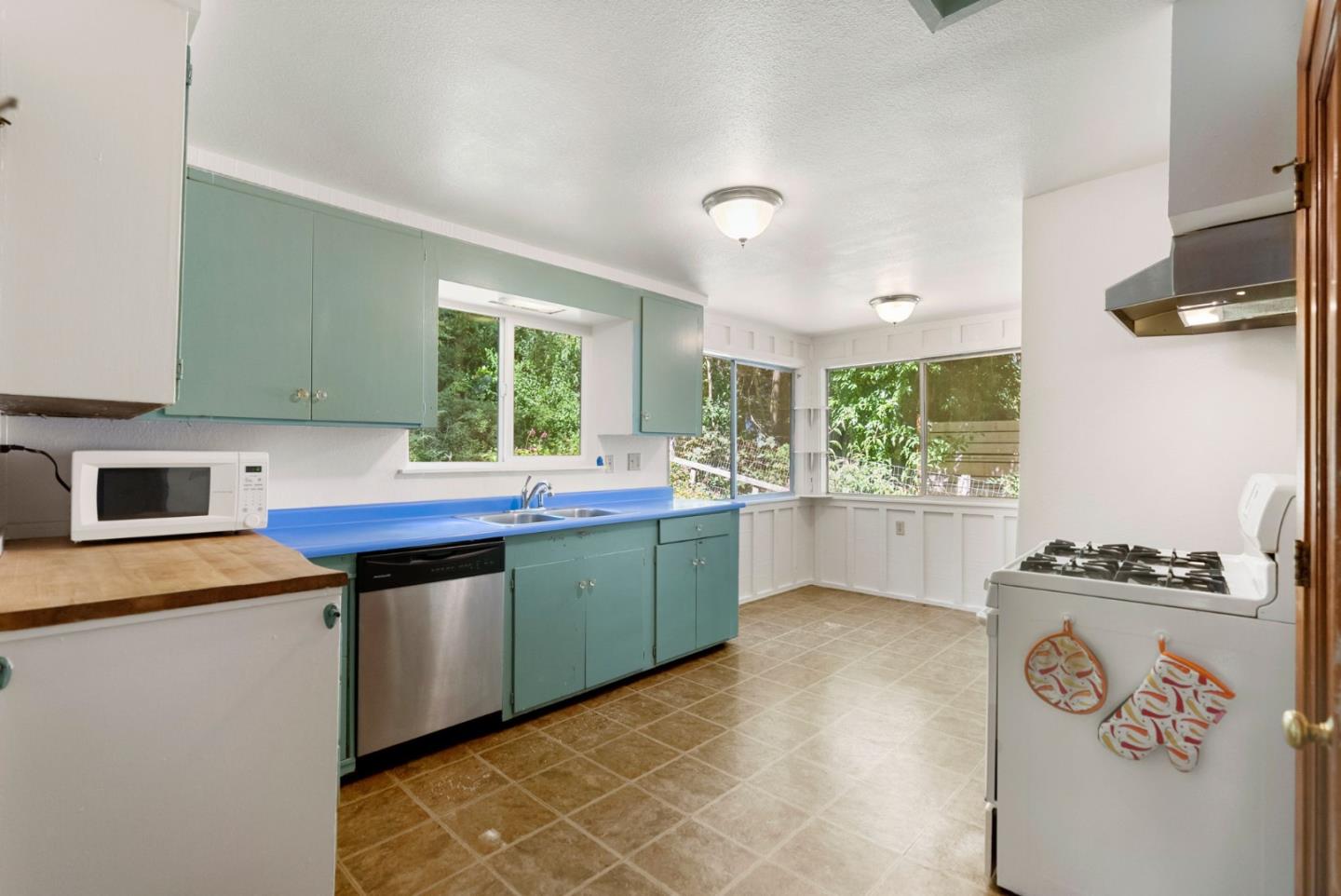324 Felton Empire Road Felton, CA 95018 - Photo 16 of 43 a kitchen with stainless steel appliances granite countertop a stove a sink and a microwave