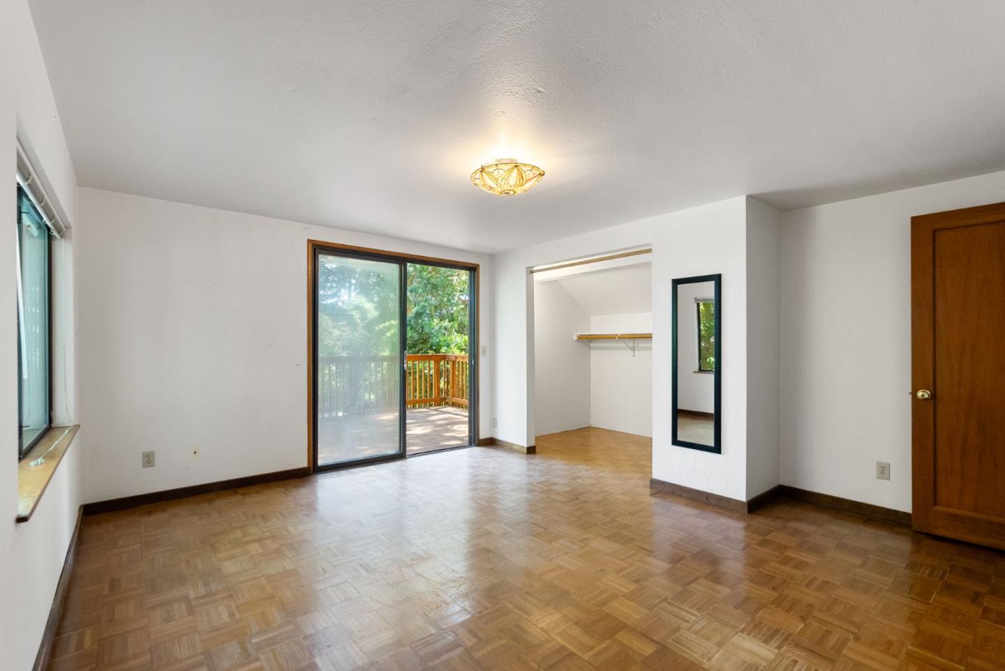324 Felton Empire Road Felton, CA 95018 - Photo 19 of 43 a view of an empty room with a window and wooden floor