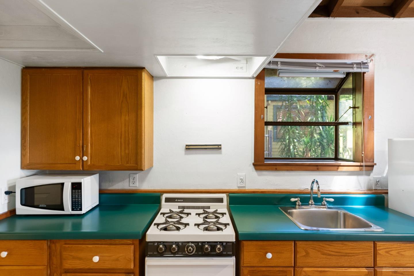 324 Felton Empire Road Felton, CA 95018 - Photo 32 of 43 a kitchen with a stove a sink and a microwave