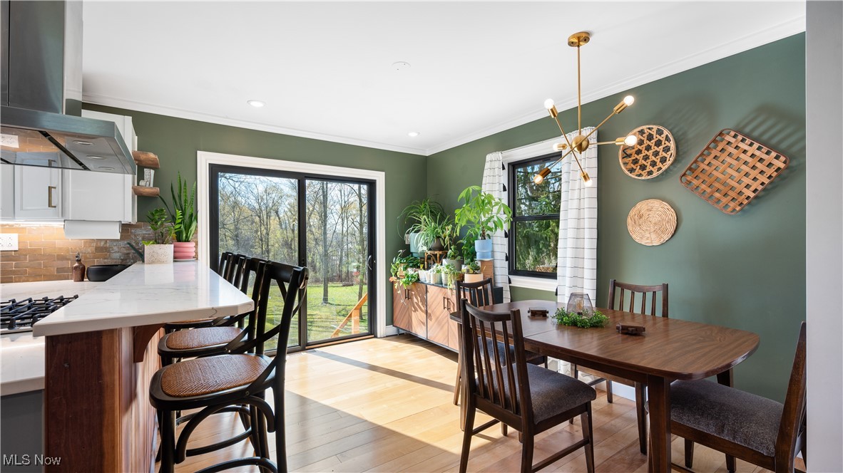 8410 Shepard Road Macedonia, OH 44056 - Photo 12 of 34 Dining area with light wood finished floors, recessed lighting, a chandelier, and ornamental molding