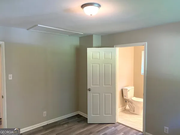 an empty room with wooden floor and a window