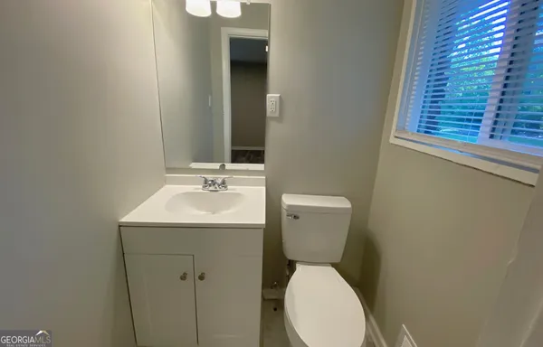 a bathroom with a sink a toilet and bathtub