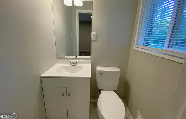 a bathroom with a sink a toilet and bathtub