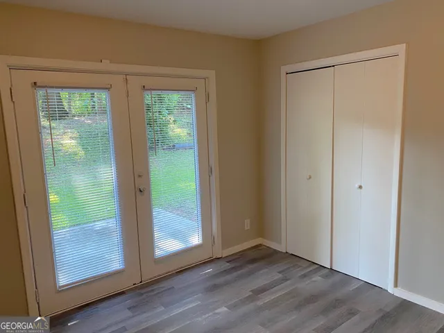 a view of a hallway with wooden floor