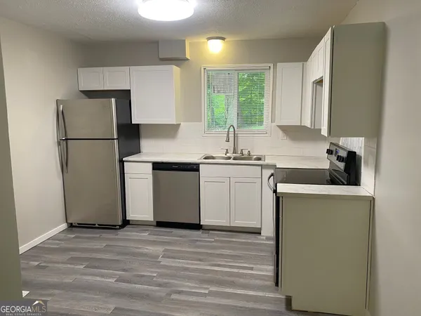 a kitchen with a sink stove and refrigerator