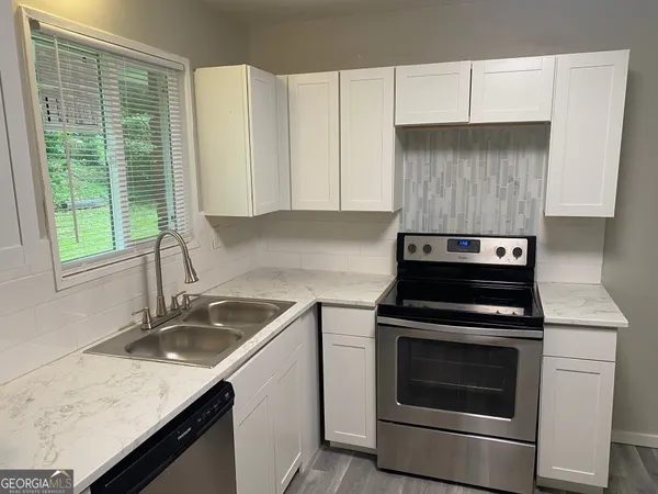 a kitchen with a stove and a sink