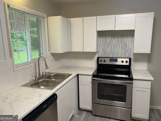 a kitchen with a stove and a sink