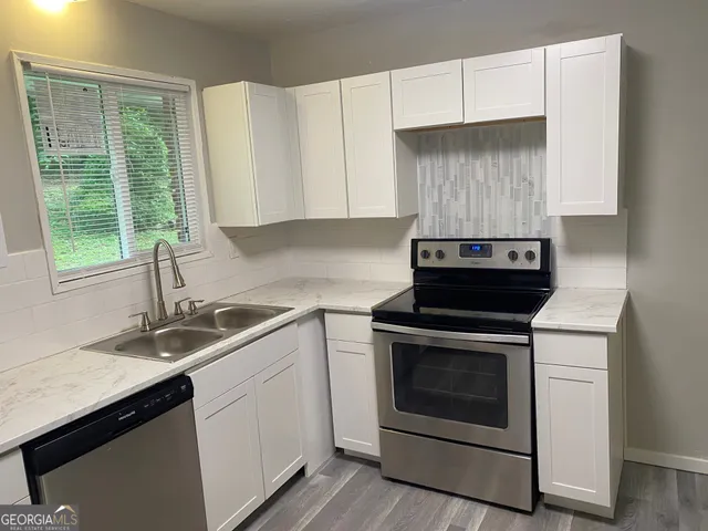 a kitchen with a sink stove and refrigerator