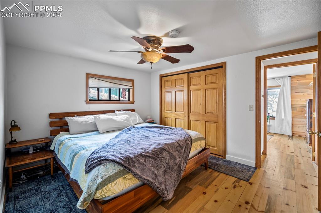 925 High Road Manitou Springs, CO 80829 - Photo 11 of 20 a bedroom with a large bed and a chandelier