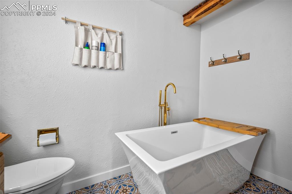 925 High Road Manitou Springs, CO 80829 - Photo 13 of 20 a bathroom with a sink a toilet and mirror