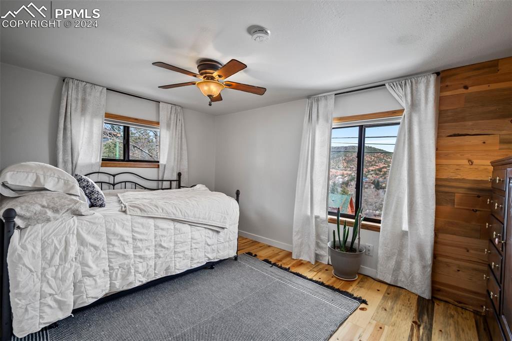 925 High Road Manitou Springs, CO 80829 - Photo 14 of 20 a bedroom with a bed and wooden floor