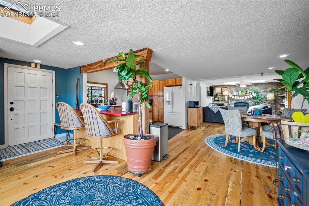 925 High Road Manitou Springs, CO 80829 - Photo 4 of 20 a living room with furniture a dining table and a potted plant