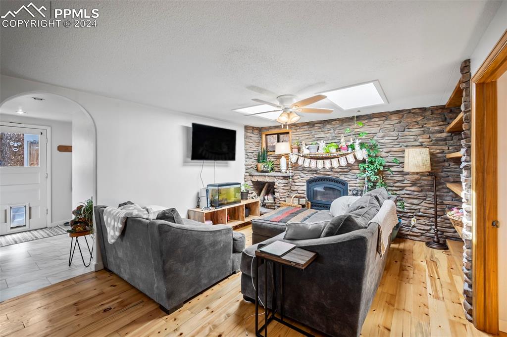 925 High Road Manitou Springs, CO 80829 - Photo 8 of 20 a living room with furniture a fireplace and a flat screen tv