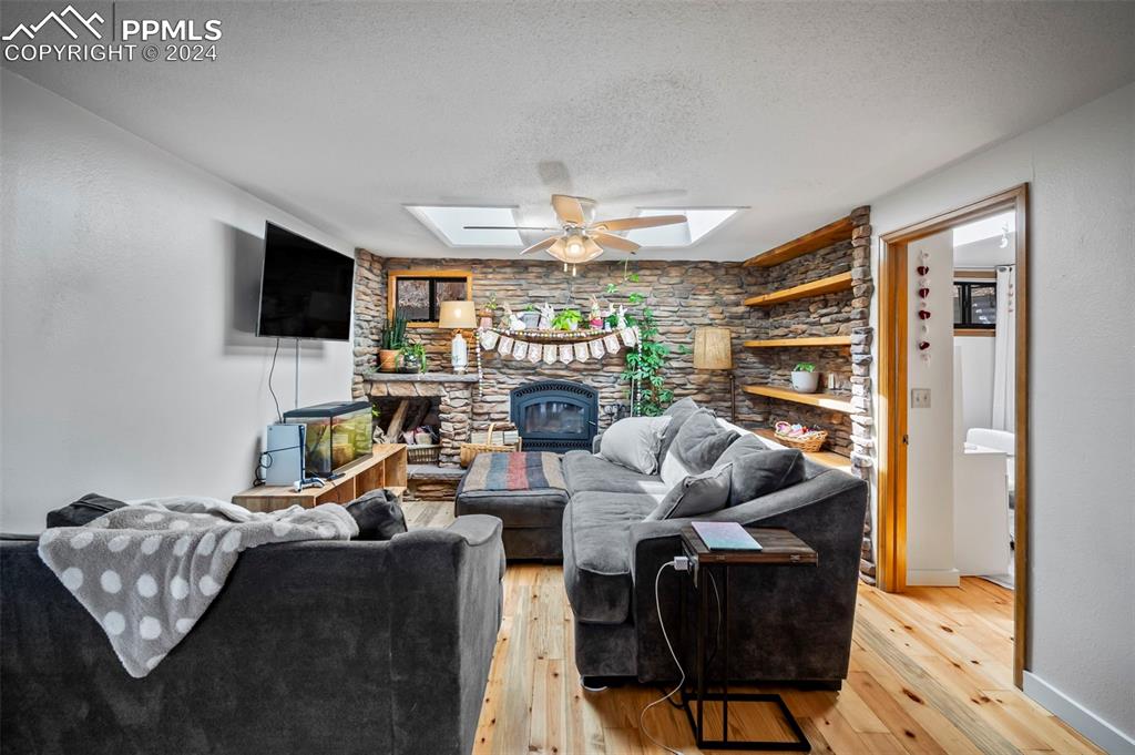 925 High Road Manitou Springs, CO 80829 - Photo 9 of 20 a living room with fireplace furniture and a flat screen tv