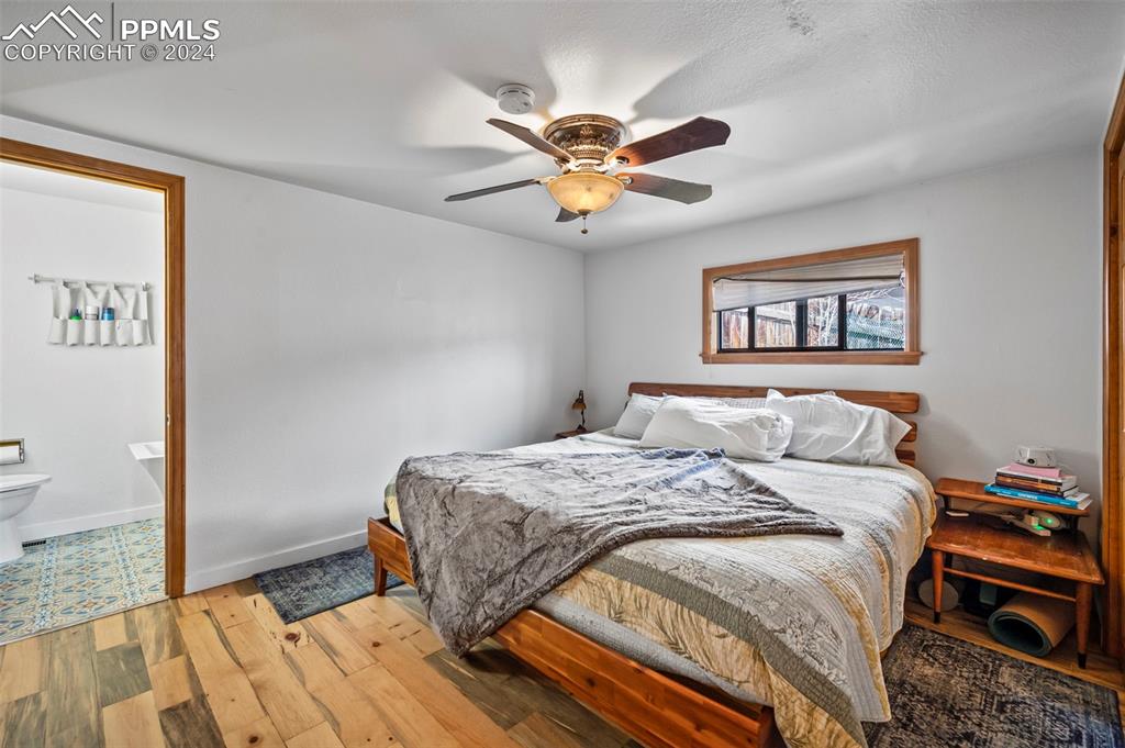 925 High Road Manitou Springs, CO 80829 - Photo 10 of 20 a bedroom with a bed and a chandelier