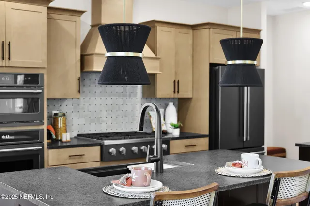 a living room with furniture a flat screen tv and a floor to ceiling window