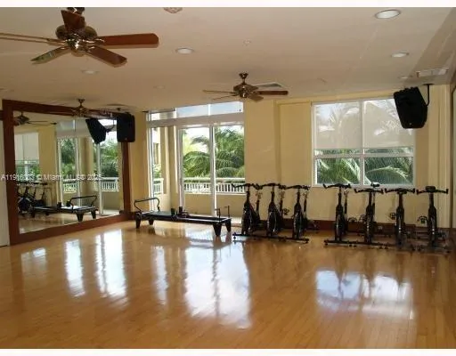 a room with pool table and windows