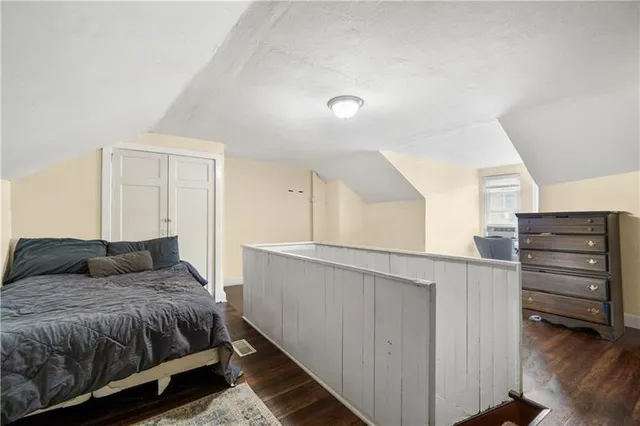 a bedroom with a bed and cabinet