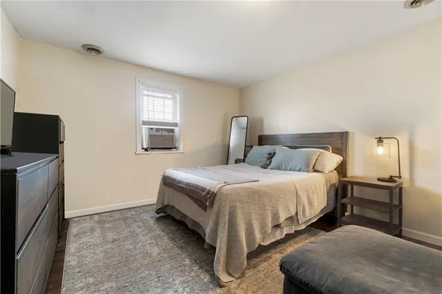 a bedroom with a bed and a tv on table